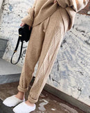 A cotton cashmere harem knit pants with mid waist, drawstring closure and lace-up detail, designed for a cozy autumn layering look that pairs from sneakers to boots.