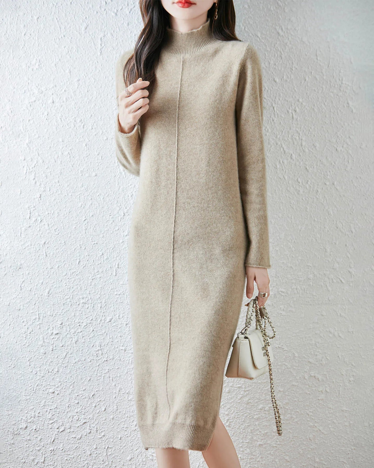 A 100% merino wool turtleneck midi dress with a straight H-line and full sleeves, designed for poised ease from a cold morning commute to dinner.