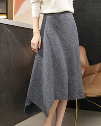A merino wool knit skirt with an asymmetric hem and elastic waist, designed for a soft, warm look that moves easily from day to night.