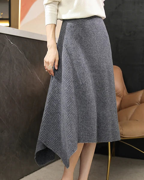 A merino wool knit skirt with an asymmetric hem and elastic waist, designed for a soft, warm look that moves easily from day to night.
