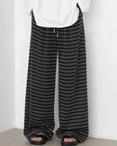 Pleats fall from a high waistline, elongating the leg into a generous wide silhouette.