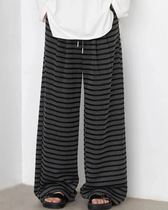 Pleats fall from a high waistline, elongating the leg into a generous wide silhouette.