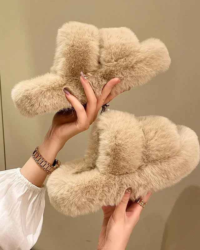 A pair of fluffy fur house slippers featuring a soft faux fur upper and a durable rubber outsole, designed for cozy warmth and non-slip comfort indoors.