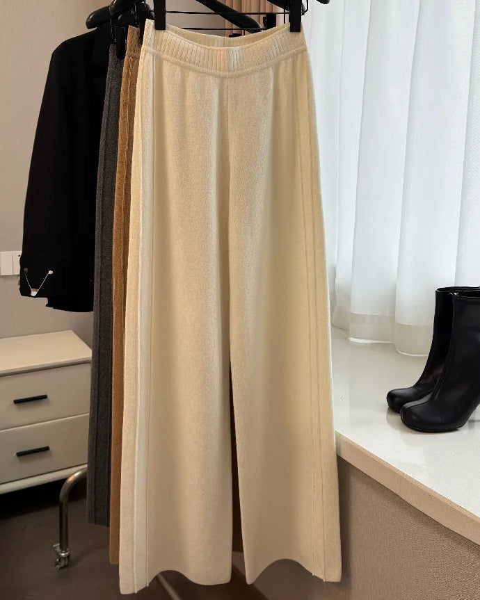 A heavyweight wool-blend wide-leg pants with elastic waist, high rise and full-length drape, designed for a cozy winter layering look that pairs from sneakers to boots.