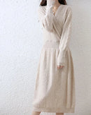 Cable-knit merino wool wrap-look dress for women with crossover V-neck, ribbed waist, flared A-line skirt and long sleeves, a soft fall-winter dress for polished wear.