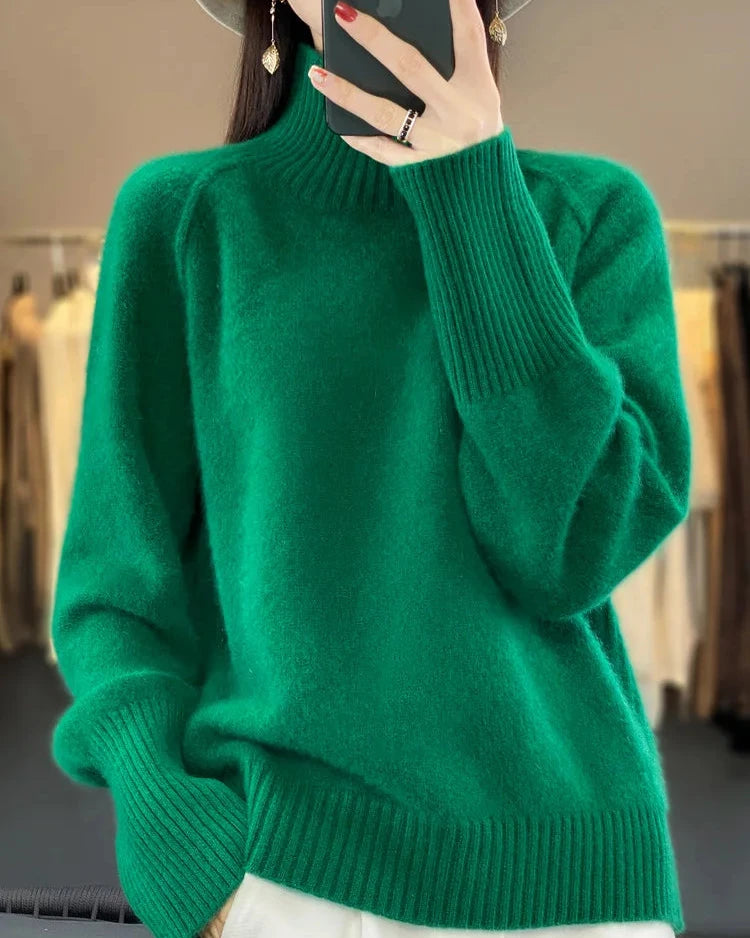 A 100% Australian merino wool mock neck sweater with a loose fit and raglan sleeves, designed for soft breathable warmth that layers easily over tees and shirts.