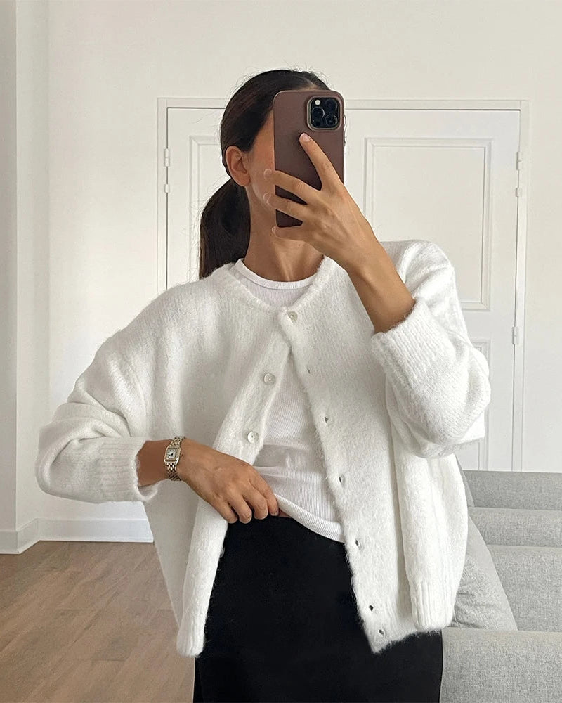 Designed for women who appreciate the quiet luxury of exceptional fabric, this slim-fit knit cardigan wraps the body in a rich, dense weave that feels indulgent to wear.