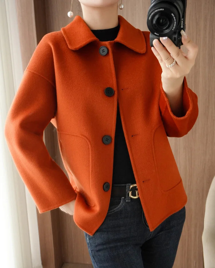 The single breasted closure and turn down collar lend tailored clarity, while full sleeves provide comfortable coverage.
