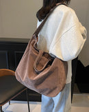 An easy shoulder tote that slouches naturally as you walk. Suede texture catches light in soft shifts, elevating the simplest outfit without effort.