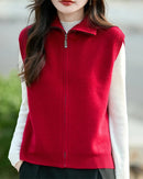 A high-neck merino wool zip vest with high collar, full-length zipper, ribbed edges, sleeveless, regular fit, designed for a cozy winter layering look that pairs from sneakers to boots.