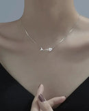 A clavicle necklace featuring a crystal-embellished fish bone pendant on a delicate chain, designed for a playful, nature-inspired look with a lobster clasp.