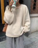 The thick knit structure retains warmth through the coldest months, while the rounded rolled neckline keeps the look understated.