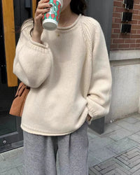 The thick knit structure retains warmth through the coldest months, while the rounded rolled neckline keeps the look understated.