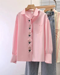Designed for quiet sophistication, this long sleeve shirt pairs a structured polo neckline with discreet button accents.