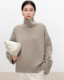 Discover our ultra-soft oversized turtleneck sweater with ribbed details and wool-cashmere blend. Perfect for winter layering, office styling, and cold-weather comfort. 