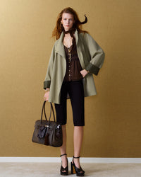 Designed for the woman who dresses with precision, this belted cropped coat offers a clean, considered aesthetic.