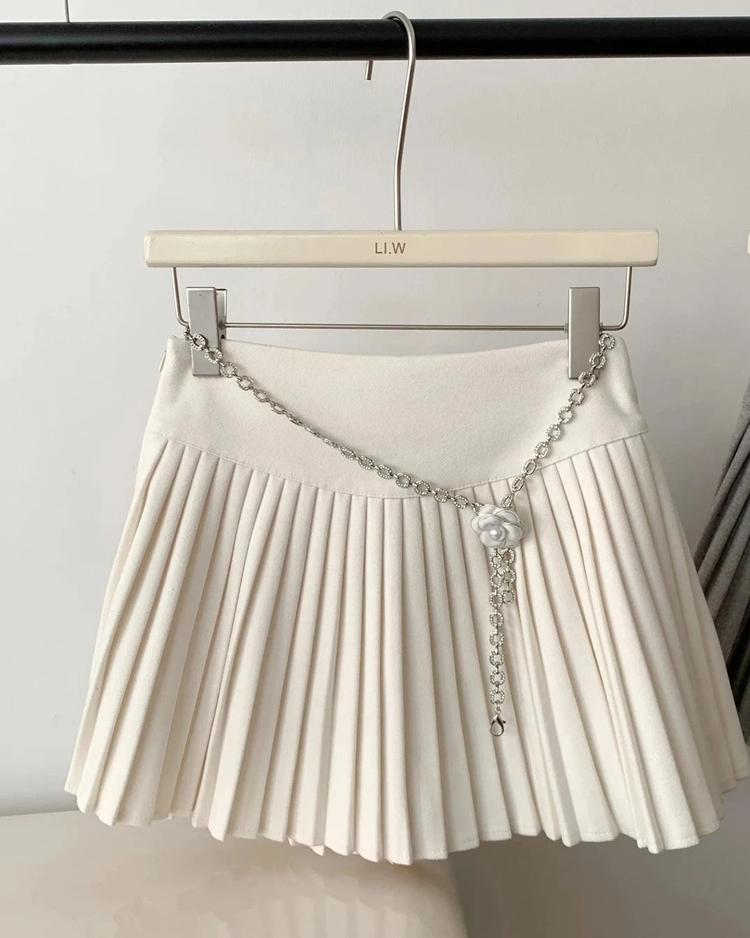 A cotton-blend A-line mini skirt with a natural waist and structured fit, designed for a polished winter look that pairs from tights to boots.