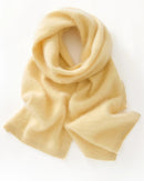 A seamless merino wool scarf with single-thread knit construction and solid-color design, designed for a cozy winter layering look that pairs from sneakers to boots.