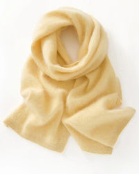 A seamless merino wool scarf with single-thread knit construction and solid-color design, designed for a cozy winter layering look that pairs from sneakers to boots.