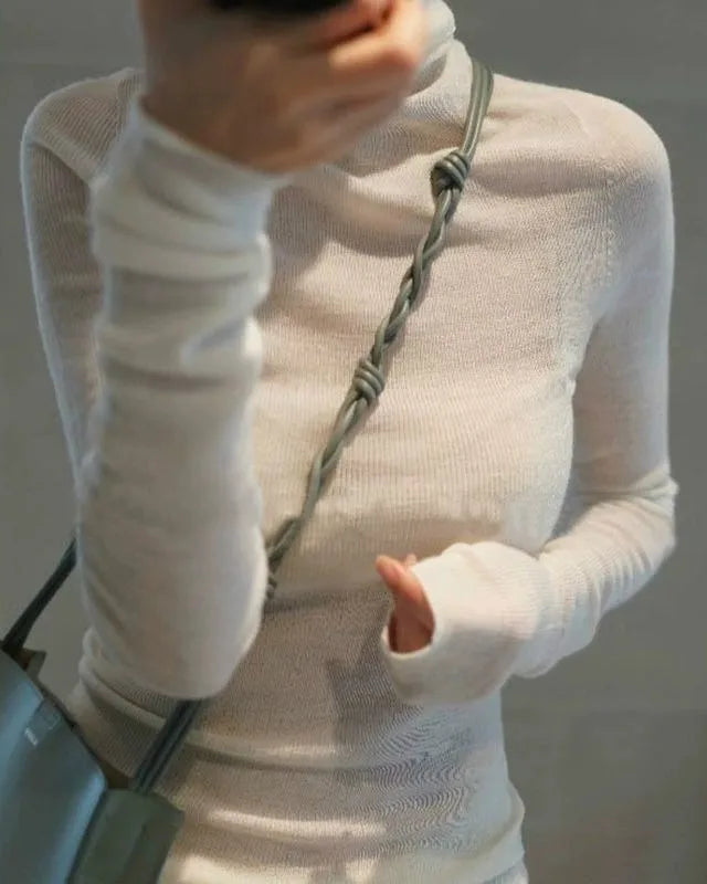 Slim-fit stretch wool turtleneck sweater with long sleeves and high neckline, showing the smooth fine-gauge knit texture styled with jeans and layered under a coat for autumn and winter.