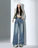 Shop Gentle Herd's high-waist wide-leg denim trousers.