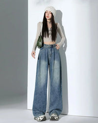 Shop Gentle Herd's high-waist wide-leg denim trousers.