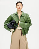 A loose-fit short jacket in PU leather featuring a turn-down collar, full-zip front, and relaxed raglan sleeves for an effortlessly cool look.