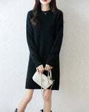 Longline merino wool crewneck sweater for women with classic crewneck, loose long silhouette, long sleeves and ribbed cuffs and hem, a soft fall-winter pullover.