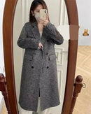 A longline coat crafted from a thick wool and cashmere blend with a turn-down collar and lace-up waist, designed for quiet winter warmth.