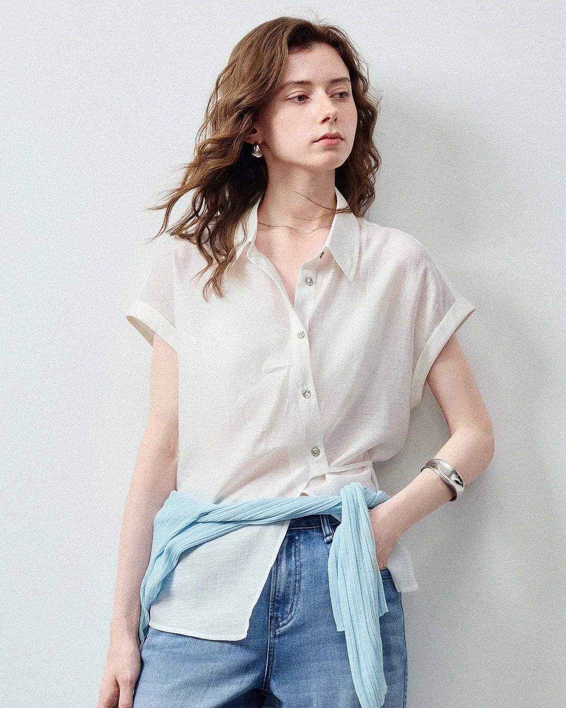 Women's Lyocell blend asymmetric waist-cinched shirt featuring a side-slit placket and rolled cuffs, crafted from lightweight fabric with beautiful drape for an effortlessly polished vacation look.