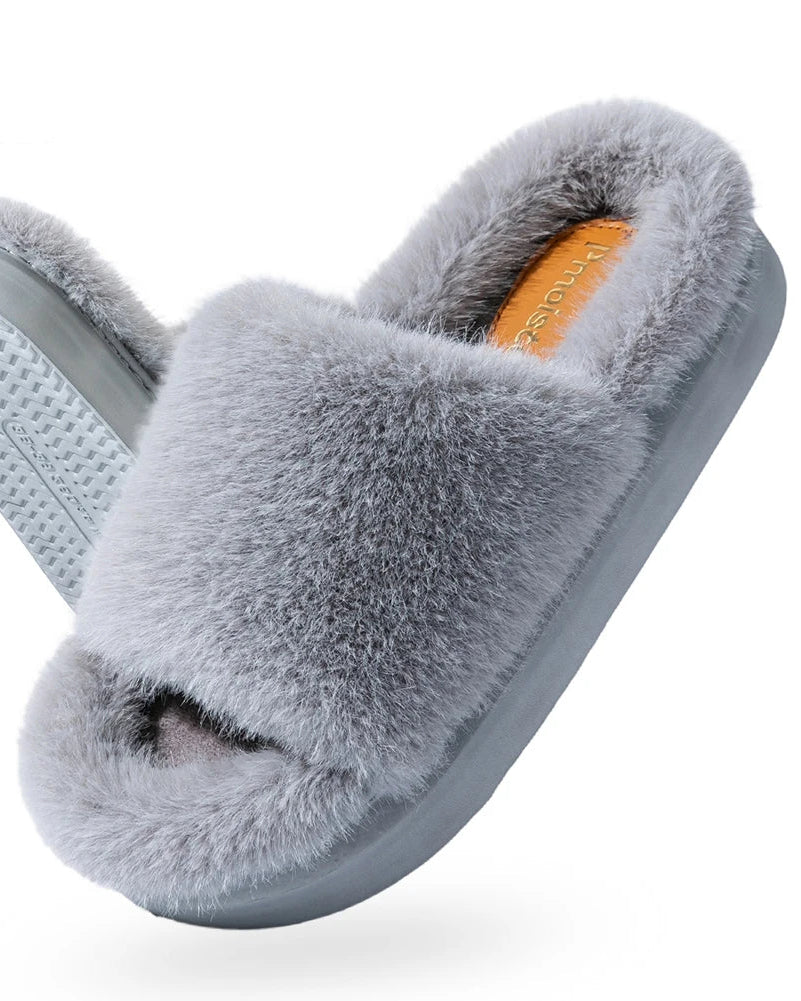 A pair of furry platform house slippers featuring a thick, soft upper and a lightweight EVA sole, designed for cozy comfort and a modern, elevated look.