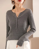 The V-neckline creates a gently elongating effect, while the heavyweight knit maintains a clean, polished drape across the body.
