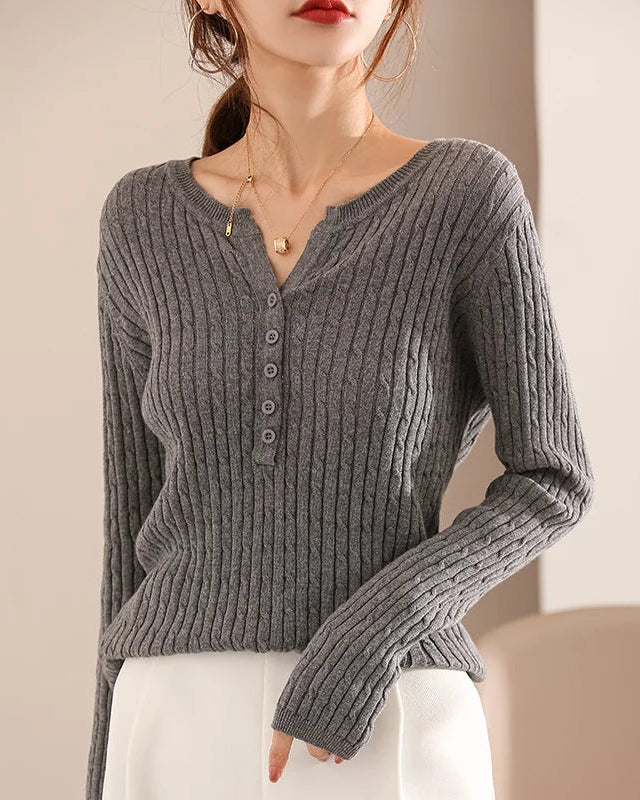 The V-neckline creates a gently elongating effect, while the heavyweight knit maintains a clean, polished drape across the body.