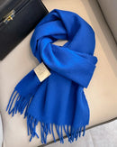 Fringed wool scarf with soft brushed texture, classic fringe ends and narrow rectangular shape, a warm solid fall-winter wool scarf for layering over coats or wrapping at the neck.