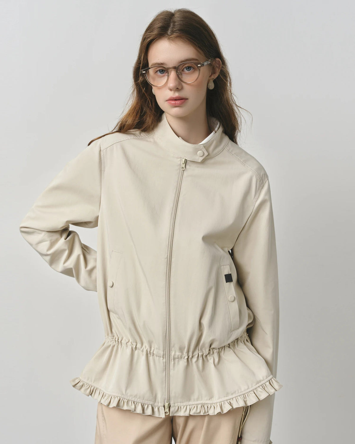 A turn down collar frames the neckline, the front zip keeps the look streamlined, and practical pockets add function without bulk.