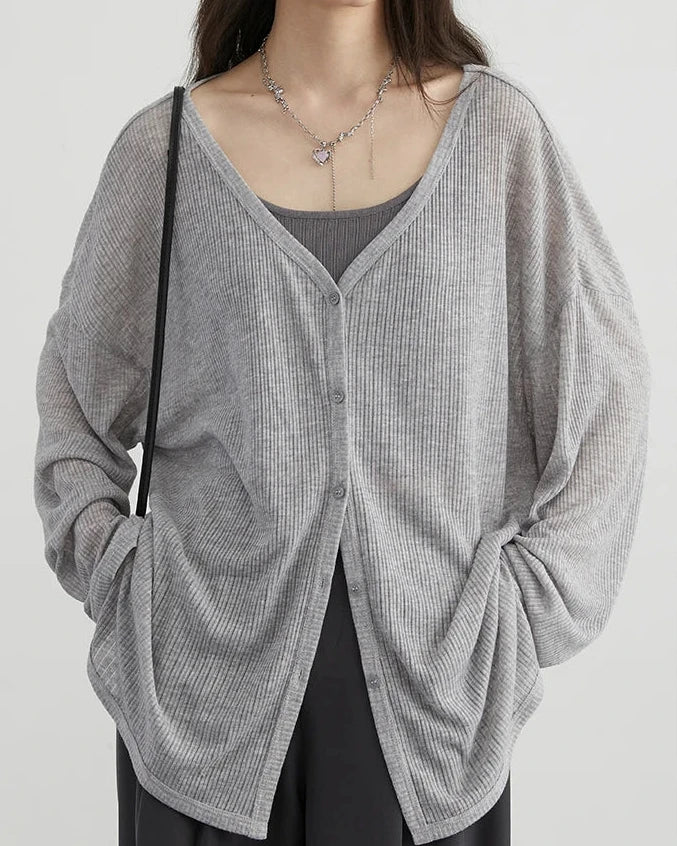 A lightweight polyester-viscose V-neck cardigan with a button front and loose fit, designed for soft polished ease that layers from workdays to weekends.
