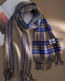 Plaid wool fringe scarf with contrasting plaid tones, fringed ends and a long rectangular shape, a warm 100% wool fall-winter scarf for wrapping or draping over coats.