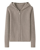 A 100% goat cashmere zip cardigan with a hood and softly padded shoulders, designed for lightweight warmth that layers easily over tees and dresses.