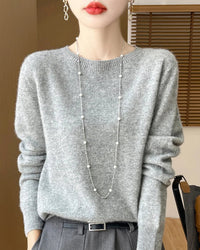 A pure merino wool pullover sweater with a clean O-neck and slim regular fit, designed for soft, versatile layering in autumn and winter.