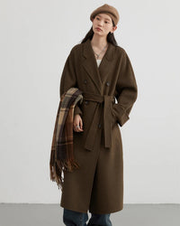 A long wool-blend coat with a double-faced finish and turn-down collar, designed for a loose, warm silhouette that drapes easily over layers.