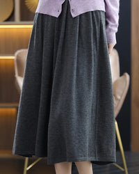 A loose, mid calf silhouette flows from a softly defined waist, while the fine knit offers breathable warmth and a gentle hand feel.