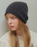 Rolled-edge wool slouch beanie with softly finished rolled opening and relaxed slouchy crown, a warm solid 100% wool fall-winter hat for commuting or weekend walks.
