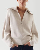 A relaxed fit allows for easy movement, while the turn-down collar and zipper detail keep the look intentional. 