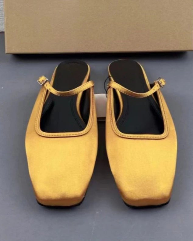 Designed for polished everyday movement, these satin flats combine a clean square toe with an open back and softly gleaming upper. 