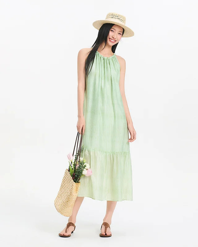Sleeveless halter maxi dress. Lyocell-nylon blend, pleated texture, A-line silhouette. Effortless summer style for vacation and everyday wear.