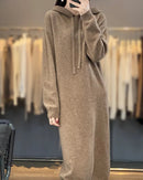 Drawstring hooded wool dress for women with adjustable hood, long plain-knit silhouette, long sleeves and ribbed cuffs, a warm fall-winter pullover dress for everyday wear.