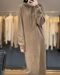 Drawstring hooded wool dress for women with adjustable hood, long plain-knit silhouette, long sleeves and ribbed cuffs, a warm fall-winter pullover dress for everyday wear.