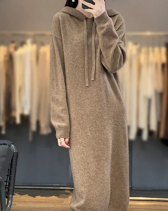 Drawstring hooded wool dress for women with adjustable hood, long plain-knit silhouette, long sleeves and ribbed cuffs, a warm fall-winter pullover dress for everyday wear.
