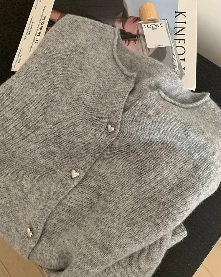 Women's gray merino wool crew-neck button-front cardigan, featuring a medium weight knit and A-line silhouette for vintage-inspired warmth this autumn.