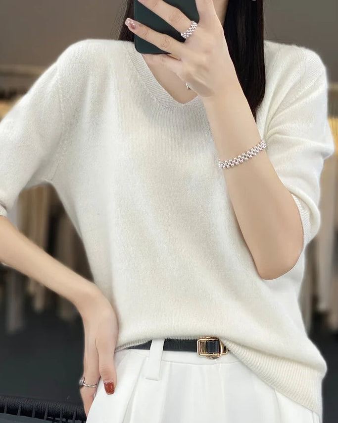 A merino wool V-neck short-sleeve sweater with V-neckline, short sleeves and soft seamless knit, designed for a light spring-summer look that pairs from sneakers to sandals.